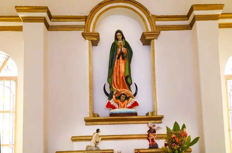 Statue of the Virgin of Guadalupe in a gilded niche inside the mission church of San José del Cabo