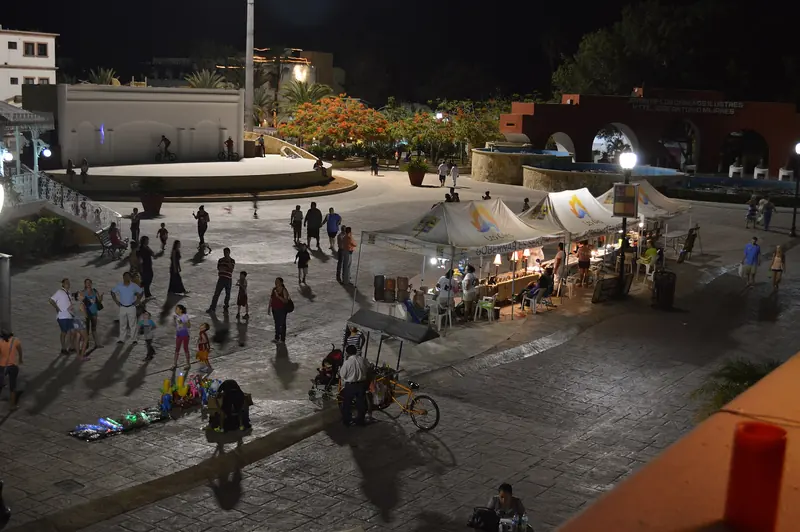The main plaza of San José del Cabo at night, with market stalls and people walking