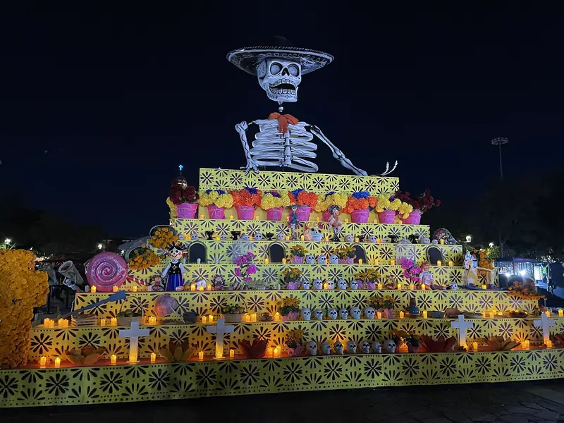 Monumental Day of the Dead altar with a skeleton figure, marigolds and candles at night in Zapopan, Jalisco