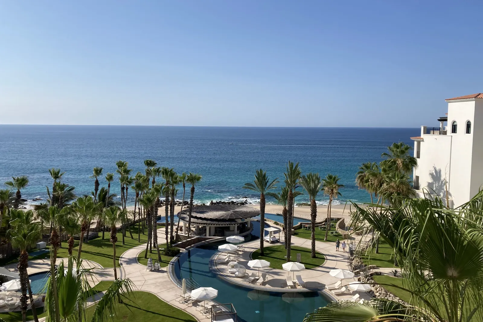 The coastline of Cabo Real on the corridor, with palms and pools above the sea