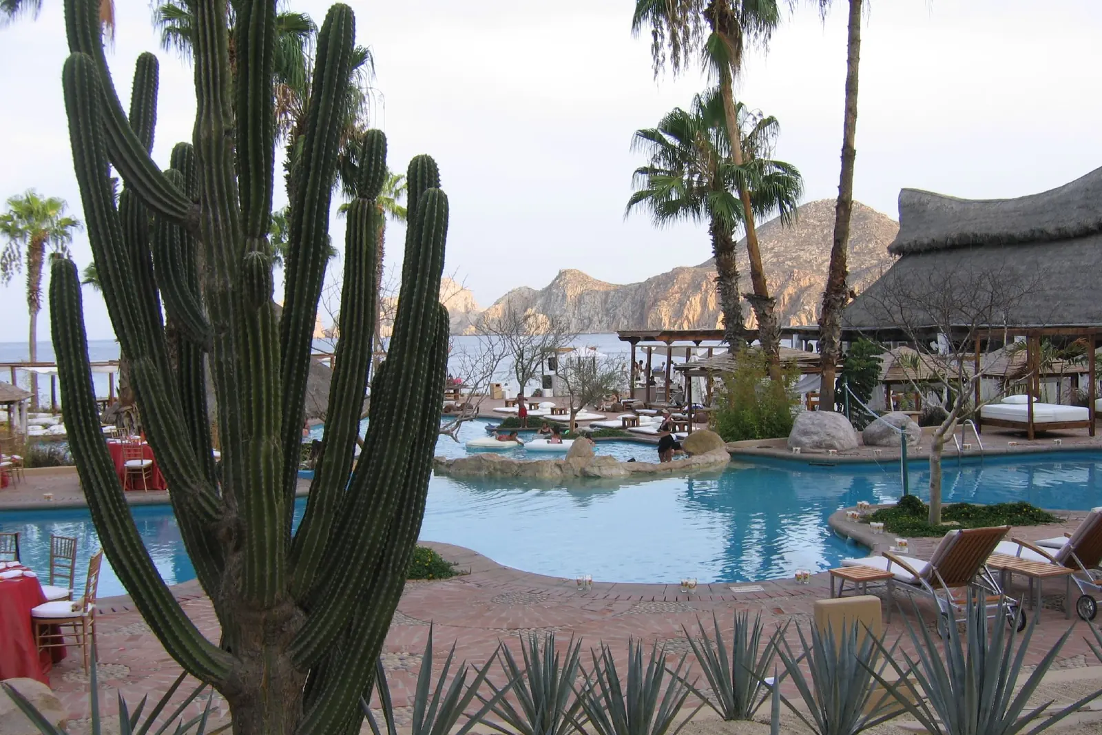 Pool and beach palapas of the hotel in 2006, then Meliá Cabo San Lucas, with Land's End behind