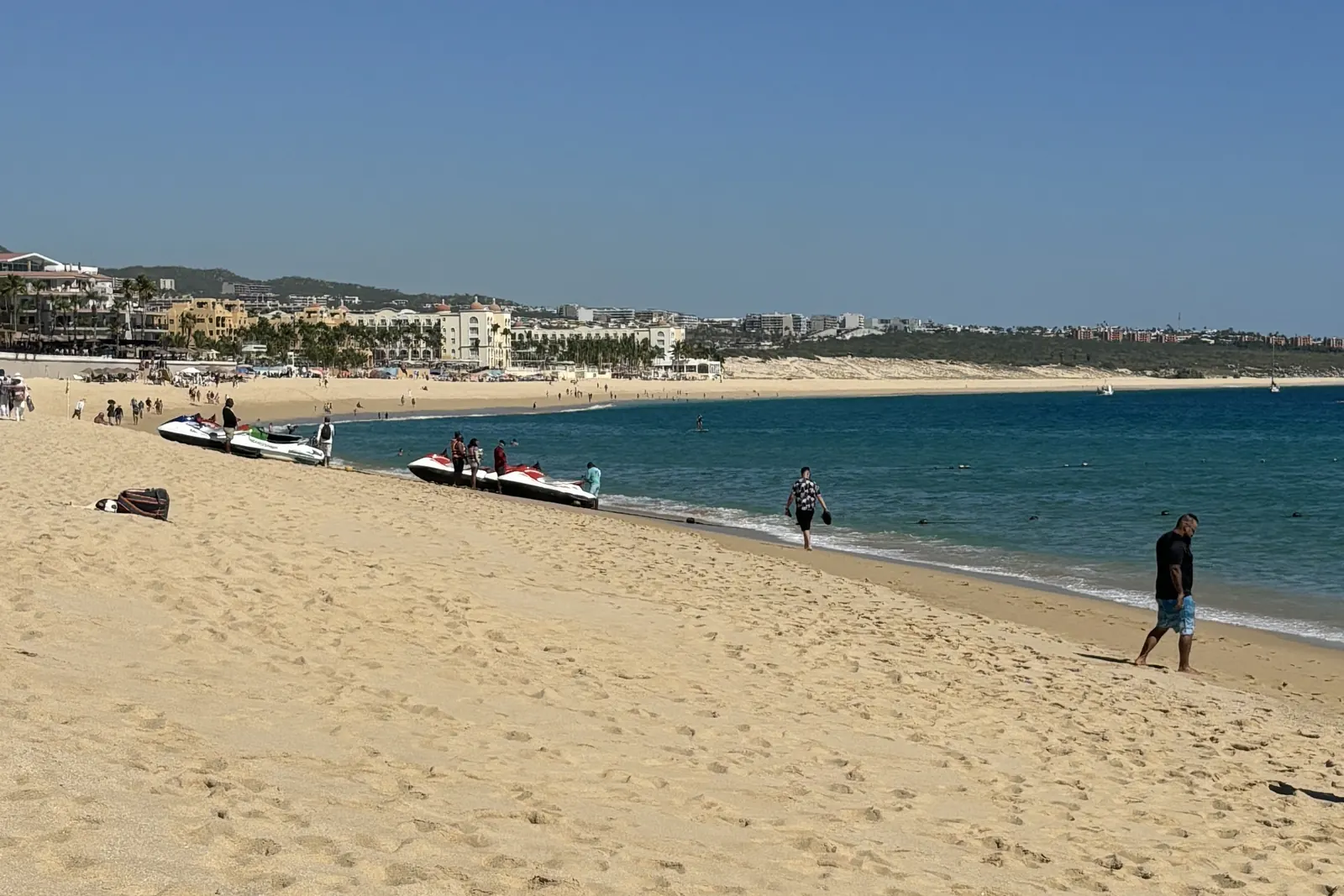 Médano Beach in front of the RIU hotels, with jet skis on the sand and hotels along the shore