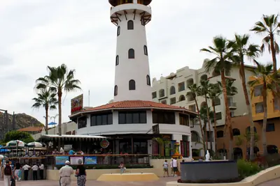 Lighthouse-style tower and hotel buildings on the Cabo San Lucas marina boardwalk, 2010