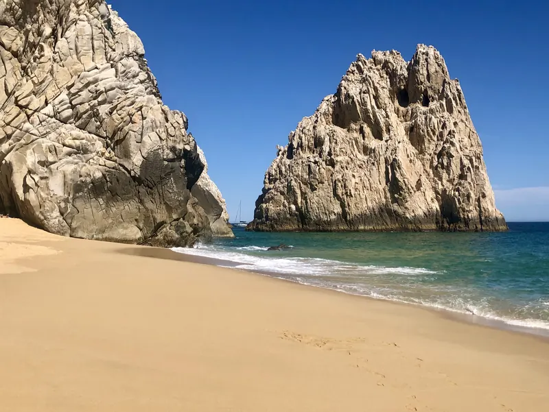 Divorce Beach on the Pacific side, with waves and an offshore rock