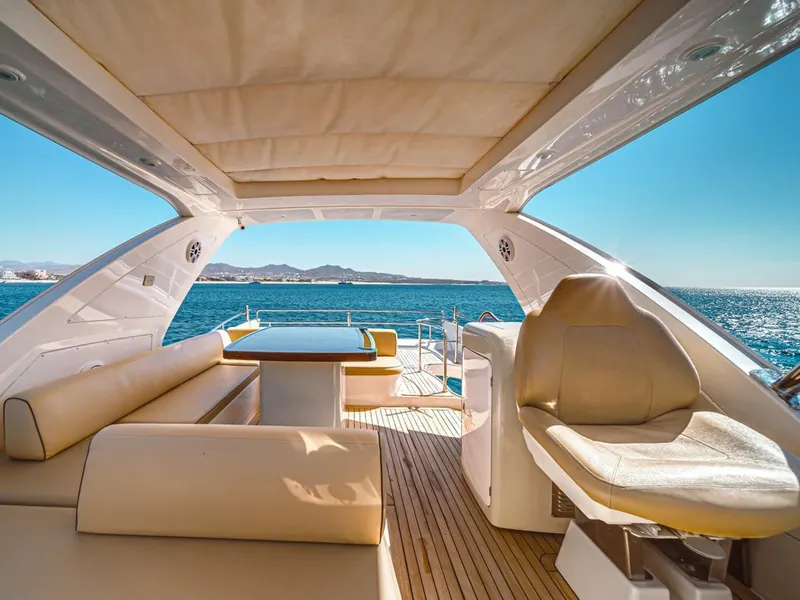 The Azimut 70's flybridge with cream seating and the sea behind it