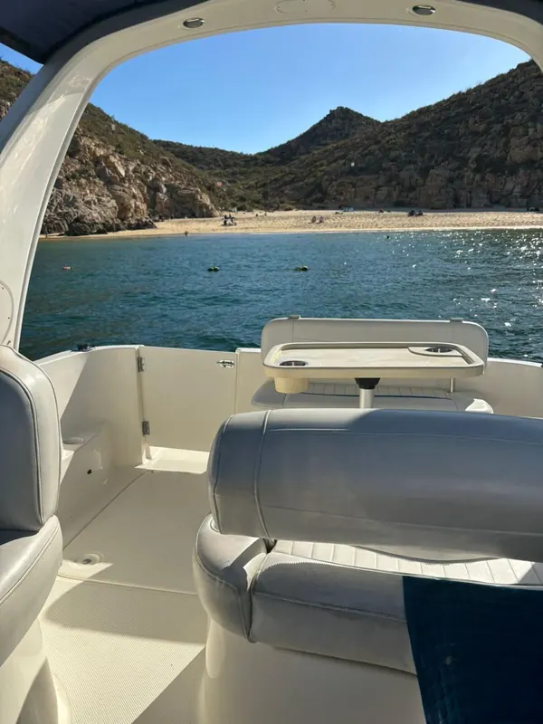 Bayliner 30 cabin cruiser anchored off a beach near Cabo San Lucas
