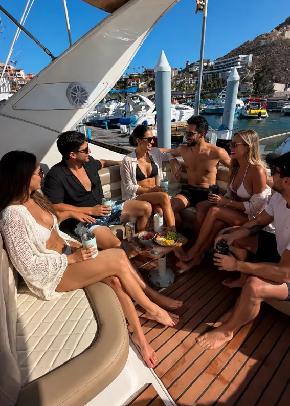 Group of friends with drinks on the deck of the Bayliner 33 at the marina