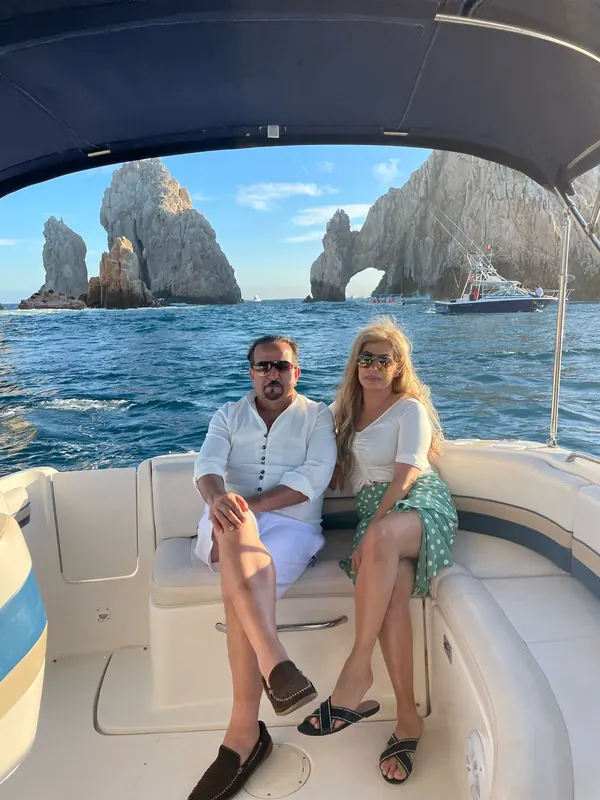 Couple seated on the Chaparral 28 with the Arch behind them