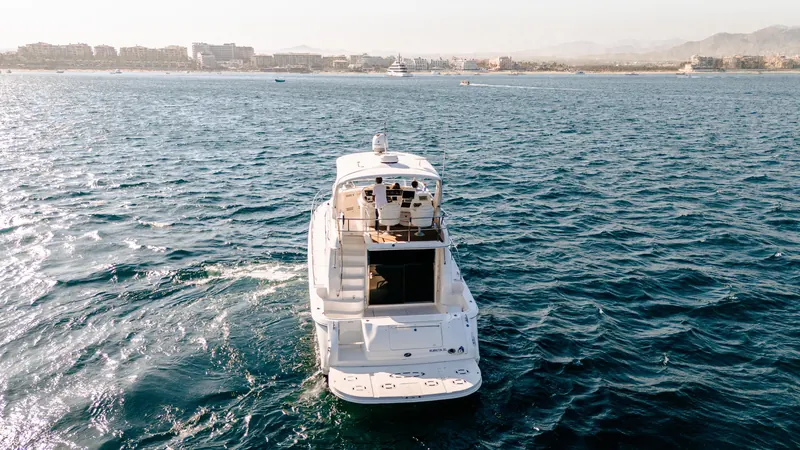 The Sea Ray 55 on the bay with the town of Cabo San Lucas behind it
