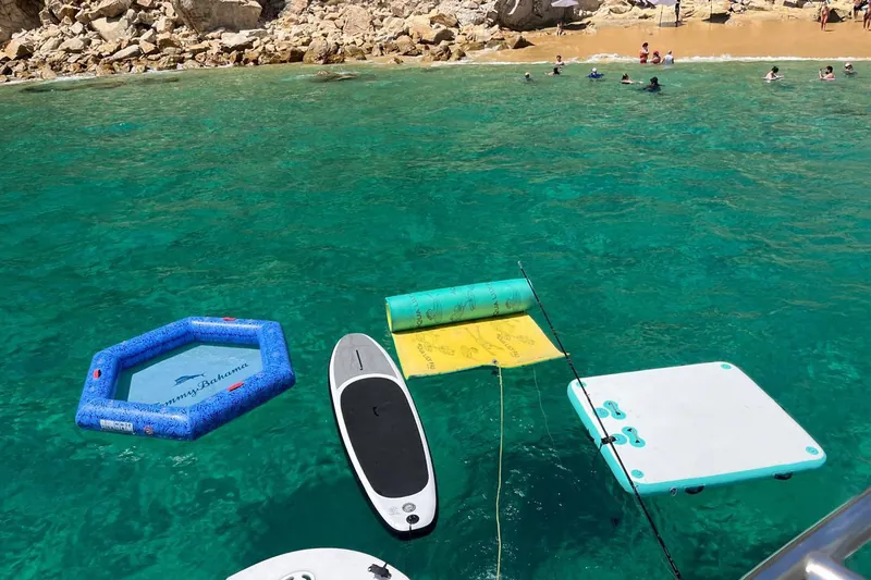 Floating pool, paddle board, lily pad and floating platform off the stern of the Sea Ray 55, in front of the beach