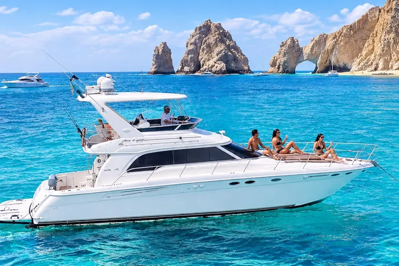 The Sea Ray 55 on turquoise water in front of the Arch of Cabo San Lucas, the backdrop most couples ask for in their photos