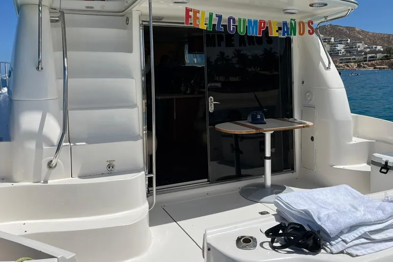 Cardstock Feliz Cumpleaños sign hung over the aft deck door of the Sea Ray 55