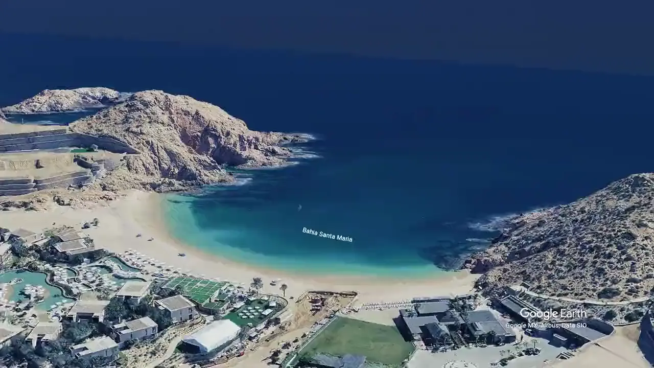 Aerial view of Santa María Bay, a turquoise horseshoe cove between two rocky headlands on the Los Cabos corridor