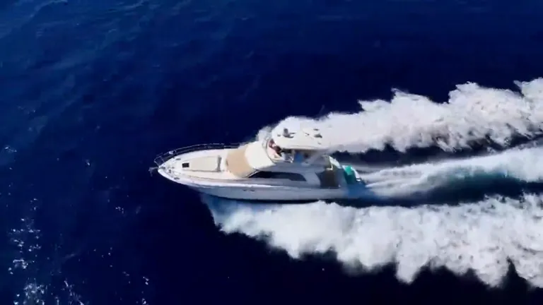 Sea Ray 55 flybridge motor yacht under way off Cabo San Lucas, seen from the air